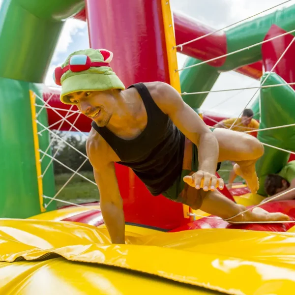 Man playing on a colourful bouncy castle